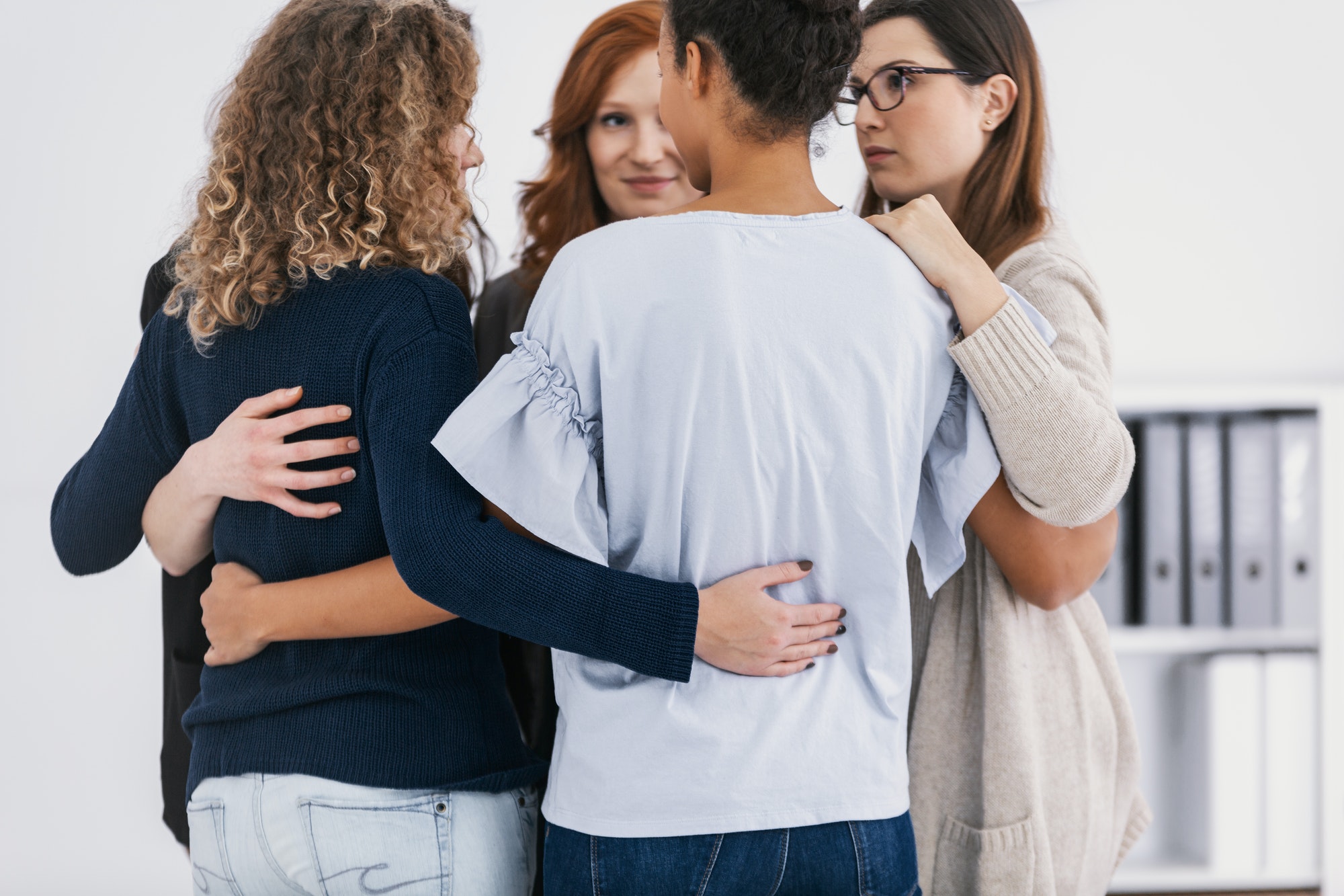 Women with issues supporting together during group therapy